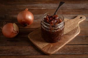 onion jam in a jar on a wooden background