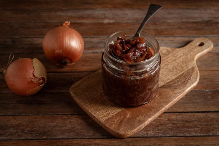 onion jam in a jar on a wooden background