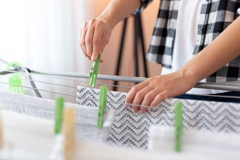 man hanging washing on a drying rack