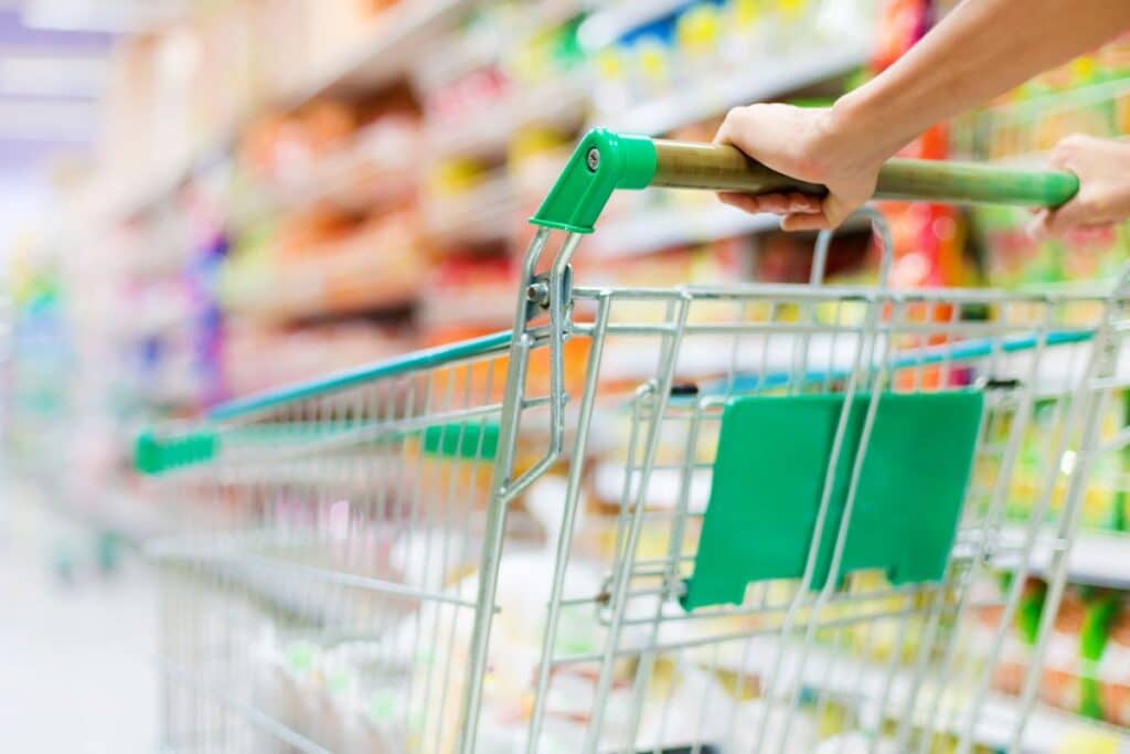 woman pushing a shopping cart in a supermarket