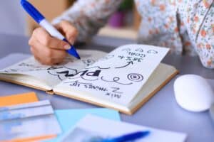 woman writing in journal about her goals and planning