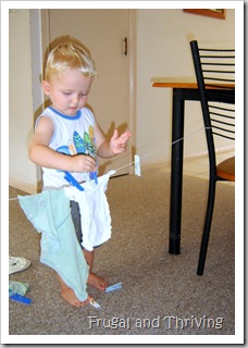 toddler playing hang the washing