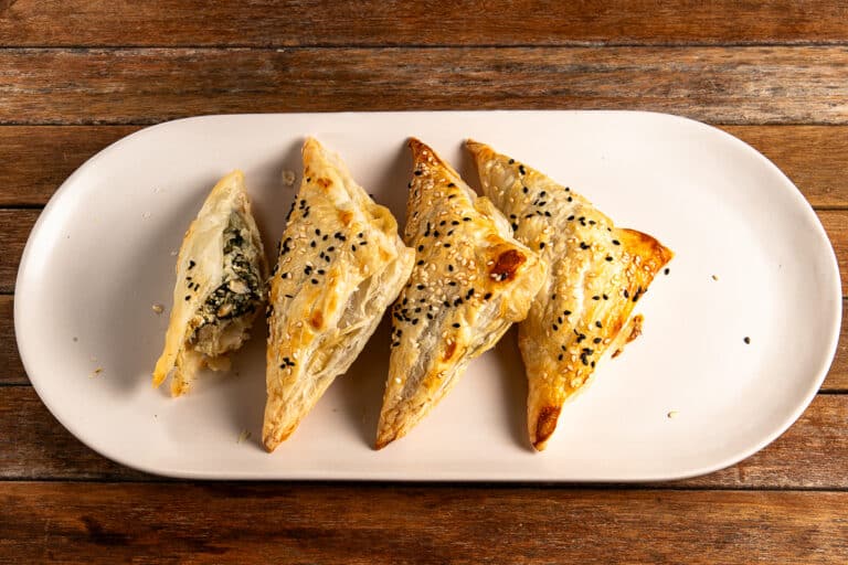 silverbeet and mushroom pastry triangles on a plate