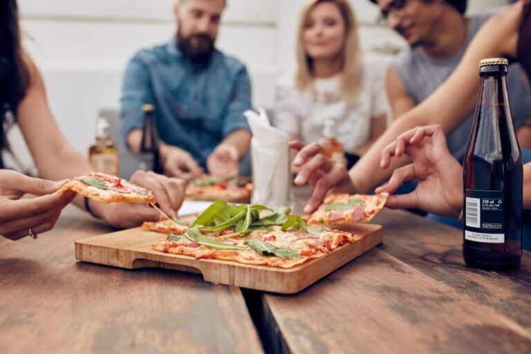 group of people sharing pizza