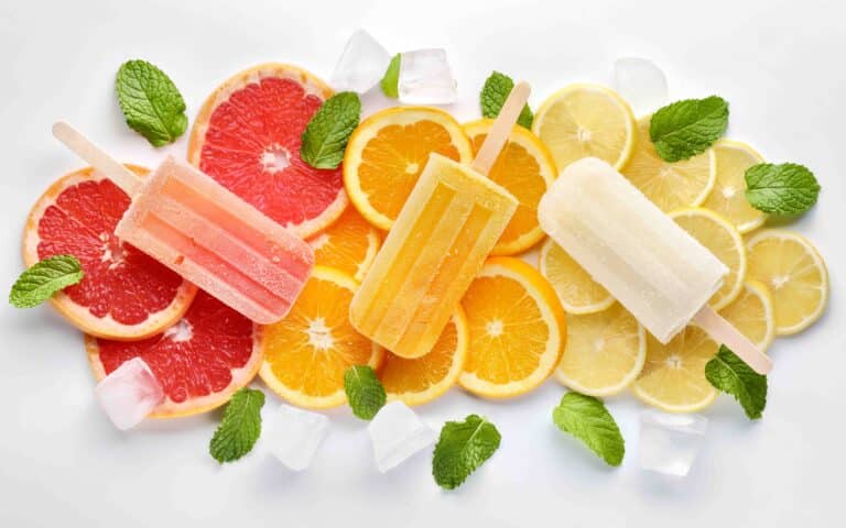 pink, orange, white ice blocks on slices of citrus