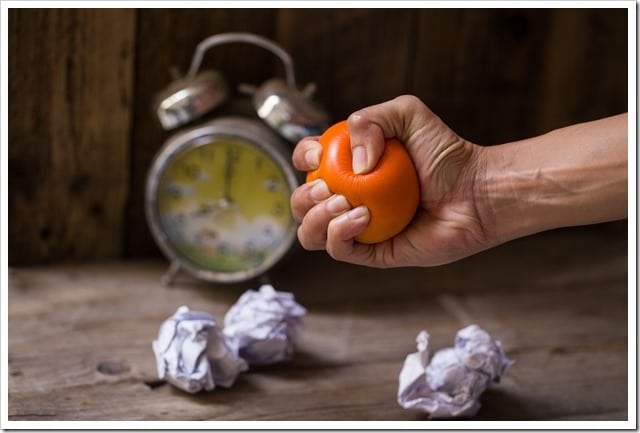 Hands of a woman squeezing a stress ball 