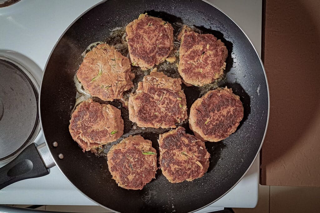 cooked tuna rissoles in a frying pan