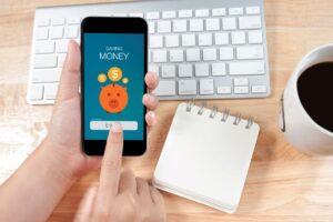 woman on mobile phone on money management app