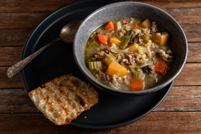 bowl of bone and barley broth with bread