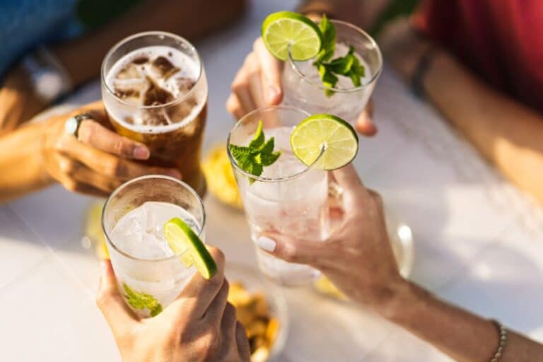 cheap fun with friends hands clinking glasses together in a toast