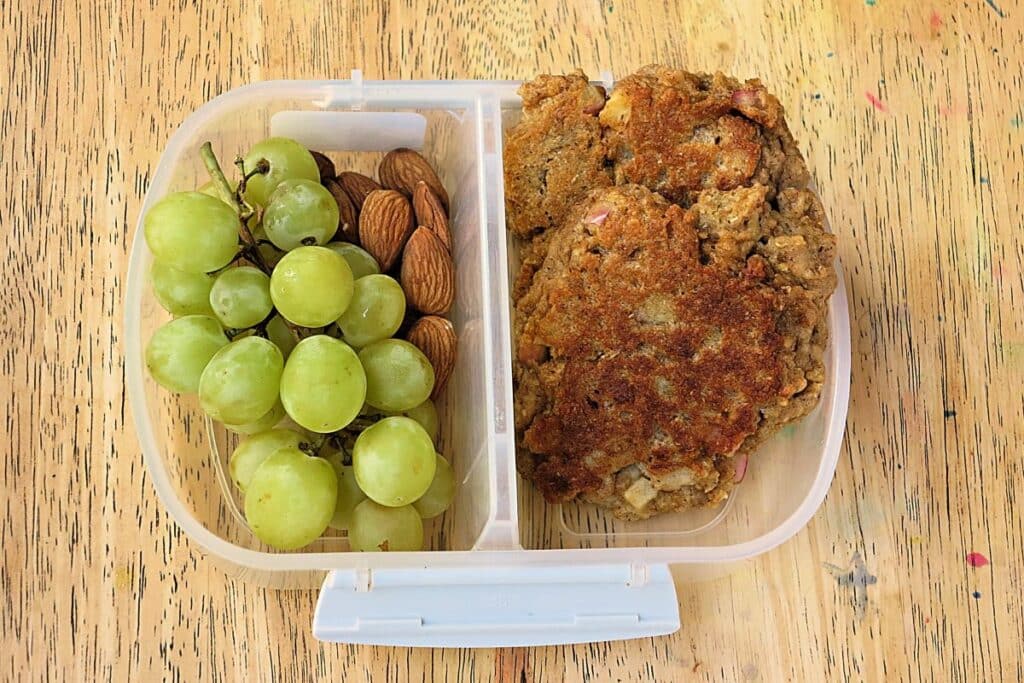 apple and weetbix pikelets in lunch box with grapes and almonds
