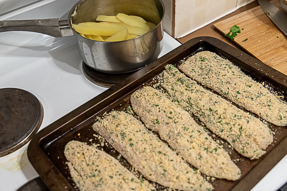 fish and chips ready to be baked in the oven.