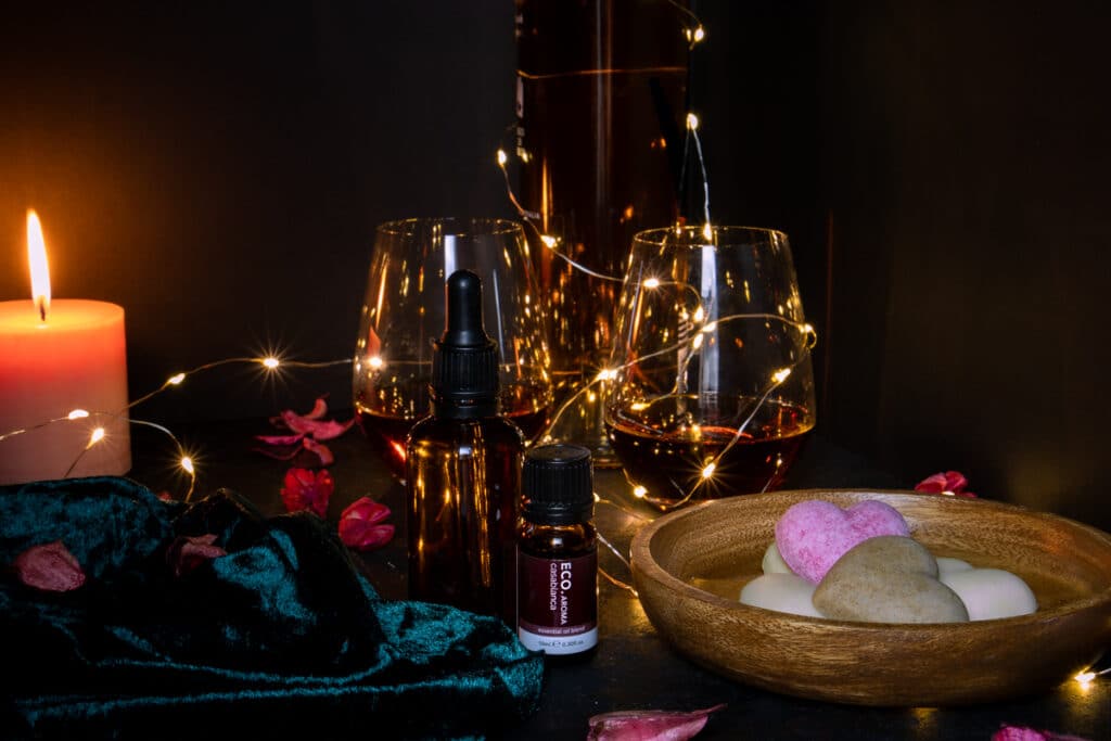 romantic atmosphere at home with wine, fairly lights, candle, essential oils, massage oils, chocolate