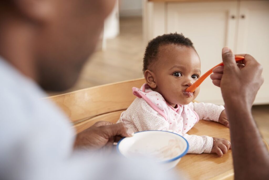 dad feeding son cereal