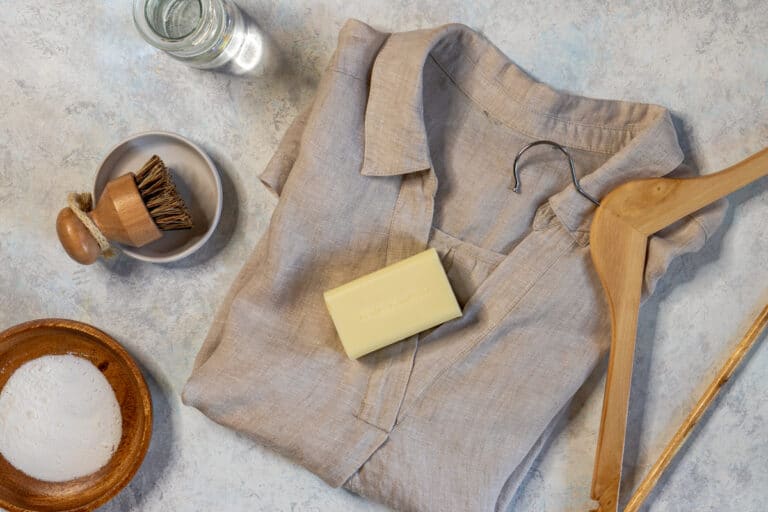 remove laundry stains flat lay with laundry soap, vinegar, washing powder, brush, coat hanger, shirt