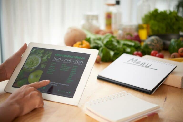 person look at recipes on a tablet while meal planning