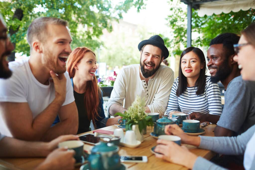 friends socialising, having coffee and laughing