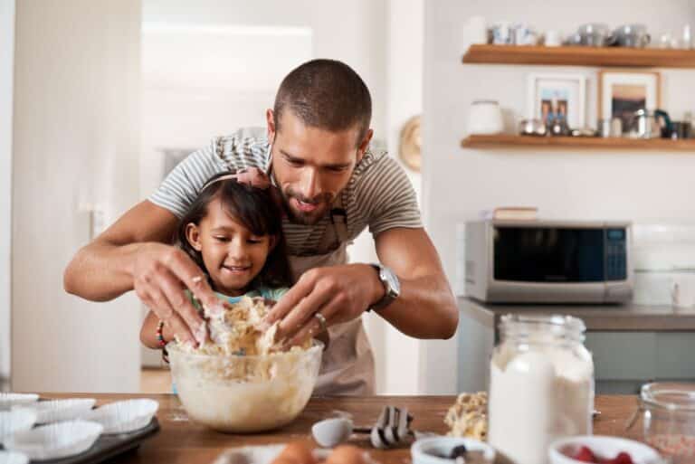 father baking with daughter