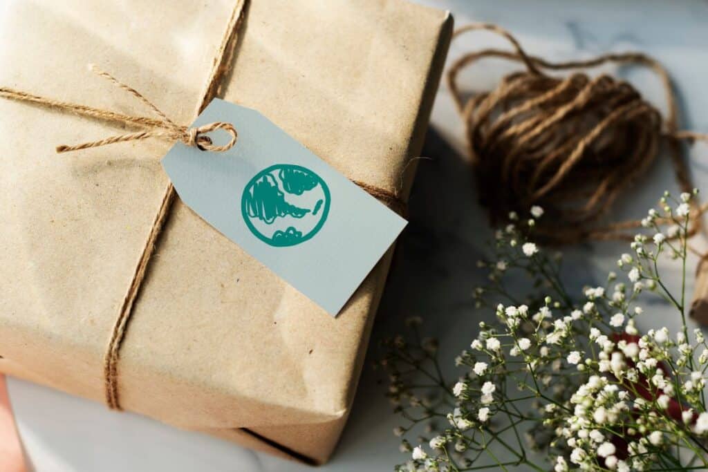 gift wrapped in brown paper and string with tag with earth drawn on it