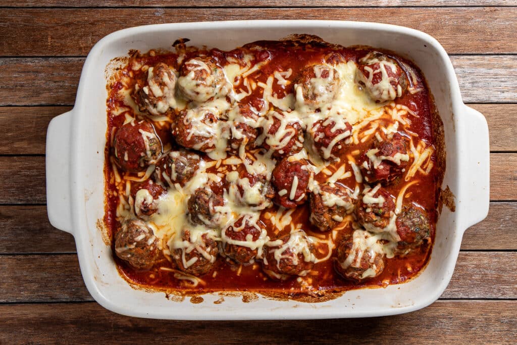 baked meatballs in marinara sauce, topped with cheese